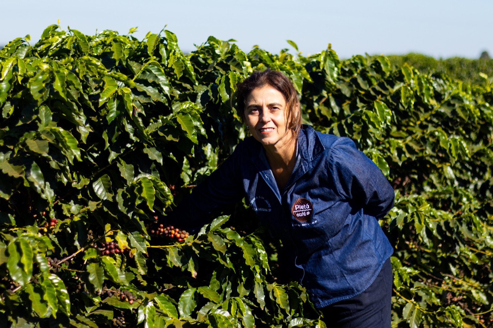 Graziela Pereira de Castro among the coffee rows.